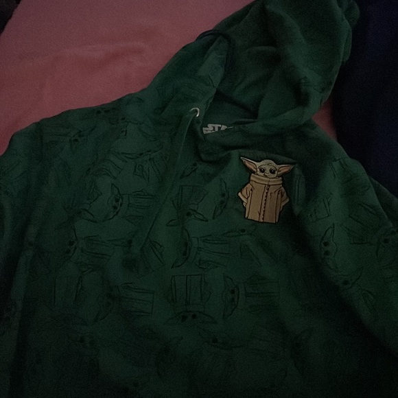 It’s a baby yoda hoodie green with little baby yoda’s over it - Picture 2 of 2